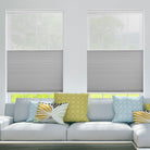 BlindsMagic motorized cellular shades installed in a bright living room with modern decor.