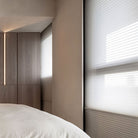 BlindsMagic motorized day and night cellular shades in a modern bedroom for 100% blackout sleep.