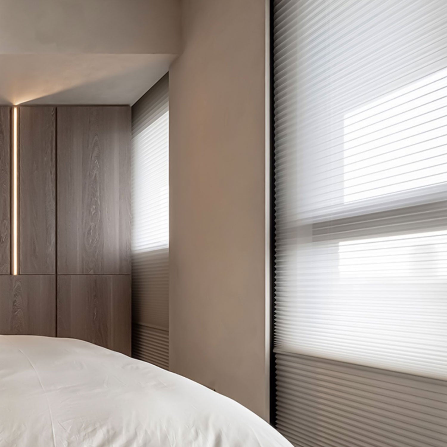BlindsMagic motorized day and night cellular shades in a modern bedroom for 100% blackout sleep.